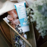 Close-up of DR. Wild Emoform Sensitive Toothpaste on a toothbrush – gentle daily oral care